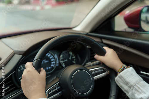 Woman driving car. girl feeling happy to drive holding steering wheel and looking on road