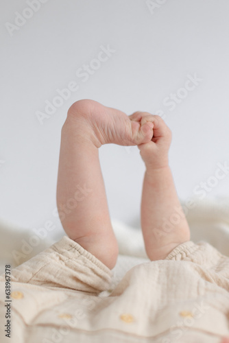 baby holding feet