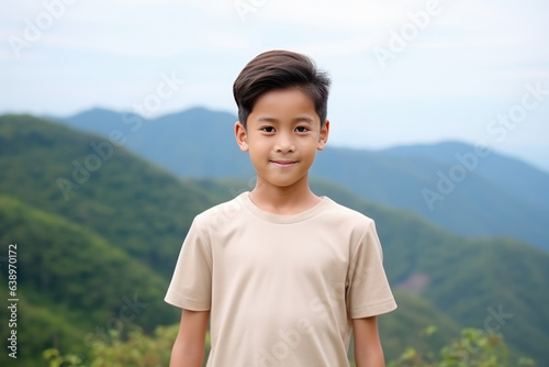 Happiness Asian Boy In Beige Tshirt On Mountain Scenery Background. Сoncept Asian Happiness, Beige Tshirt, Mountain Scenery, Positive Vibes