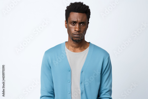 Sadness African Man In Blue Cardigan On White Background. Сoncept Grief, African Men, Blue Cardigan, White Background