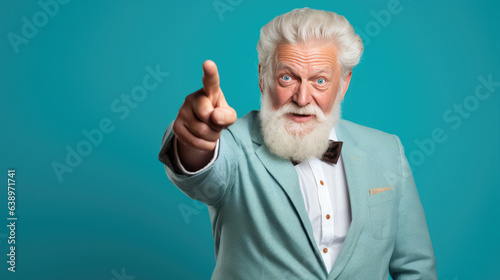 Senior man pointing with hand and finger to the side looking at the camera.