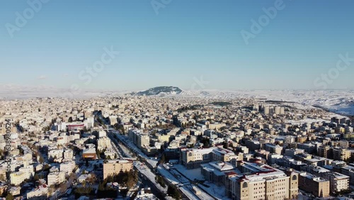 Pre-Earthquake Aerial View of Adıyaman, Turkey - Snow-Capped Urban Landscape: A serene aerial view of Adıyaman, Turkey, blanketed in snow, showcasing the city’s architecture and roads before the devas