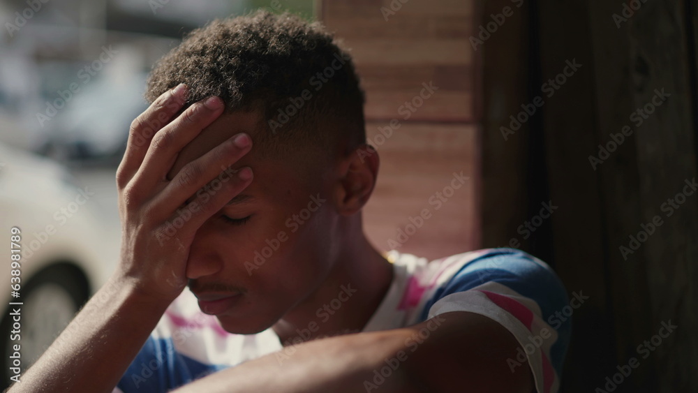 Close-up Face of Distressed Young African American Man, Frowning with Concern and Emotional Pressure, Preoccupied Worried Expression Close-up Face of Distressed Young African American Man, Frowning with Concern and Emotional Pressure, Preoccupied Worried Expression