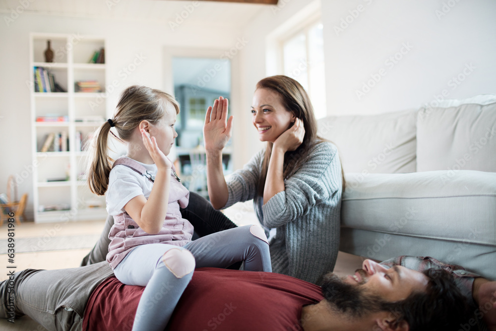 Young caucasian family having fun and playing together in the living room Young caucasian family having fun and playing together in the living room