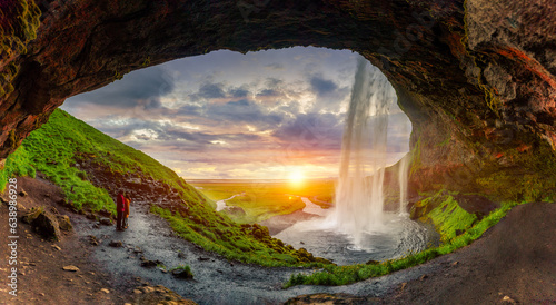 Quadro su tela Natural cave with sunset over Seljalandsfoss waterfall flowing in summer at Icel