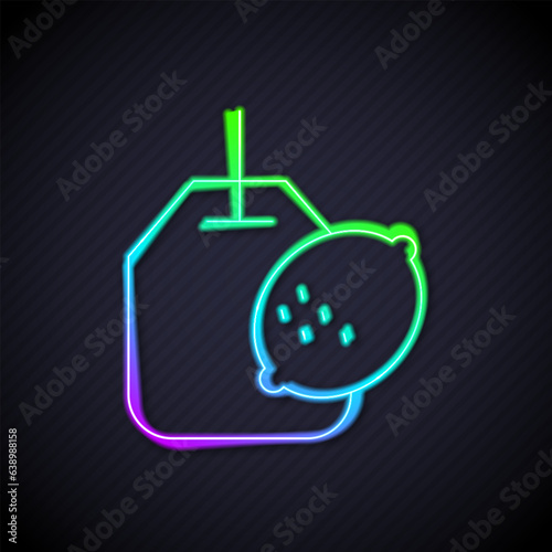 Glowing neon line Tea bag with lemon icon isolated on black background. Vector