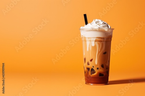 Photo Delicious Iced Cold Brew Coffee with Pumpkin Spice Isolated on a Orange Backgrou
