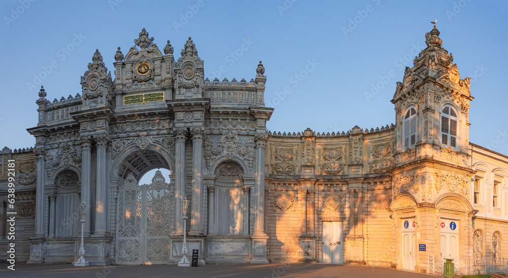 Sunset shot of closed gate leading to former Ottoman Dolmabahce Palace, or Dolmabahce Sarayi, suited in Ciragan Street, Besiktas district, Istanbul, Turkey. Panorama, panoramic view