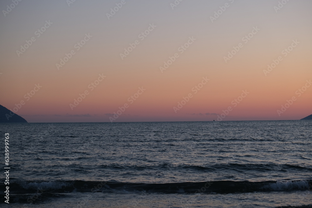 Sunset Sky over Sea Horizon in the Evening with colorful clouds Orange sunlight, Dusk Sky Background . High quality photo