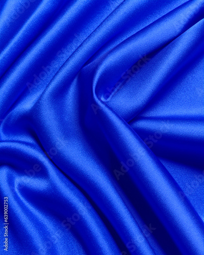 Generated photorealistic image of a dark blue satin fabric with painterly folds 