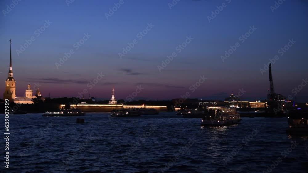 Side view from tour boat of illuminated Russian Orthodox Saints Peter and Paul Cathedral at night in Saint Petersburg, Russia. Religious architecture. Real time handheld video. Water tourism theme. Side view from tour boat of illuminated Russian Orthodox Saints Peter and Paul Cathedral at night in Saint Petersburg, Russia. Religious architecture. Real time handheld video. Water tourism theme.