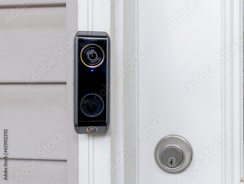 A Smart doorbell with an intercom and double camera at a residencial home entrance.