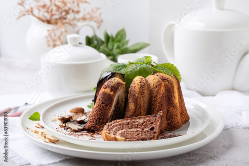 Chocolate biscuit dessert on a white dish on a white background
