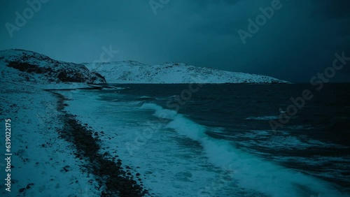 Dark atmospheric footage of Northern Barents sea. Static shot of sea waves crashing on the coast. Beautiful and severe northern nature