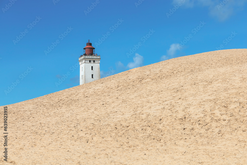 Rubjerg Knude Lighthouse on the coast of the North Sea in the Jutland in northern Denmark. Natural landscape with sand dunes. High quality photo