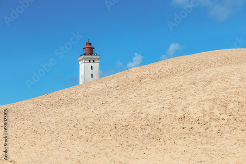 Rubjerg Knude Lighthouse on the coast of the North Sea in the Jutland in northern Denmark. Natural landscape with sand dunes. High quality photo