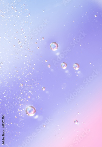 Gel texture of cosmetic products. transparent cream on a blue pink background with bubbles. macro photo. blur and selective focus.