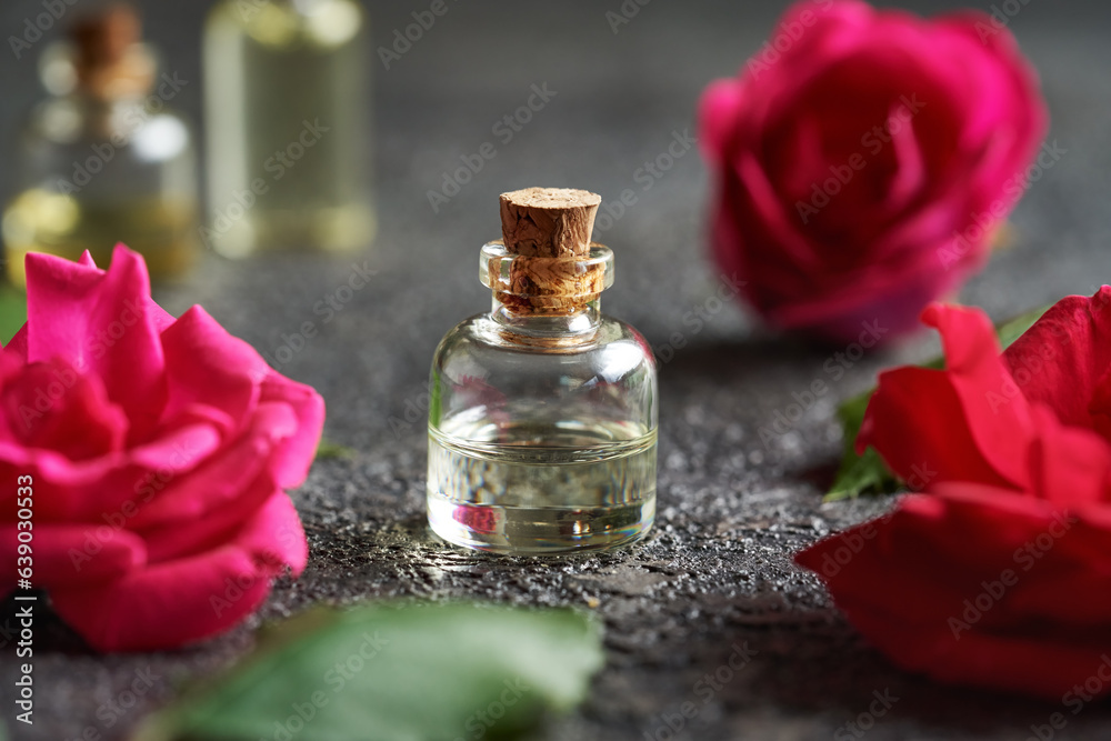 A bottle of rose essential oil on a table A bottle of rose essential oil on a table