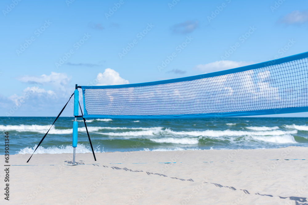 Beach volleyball and beach tennis net on the background of sand