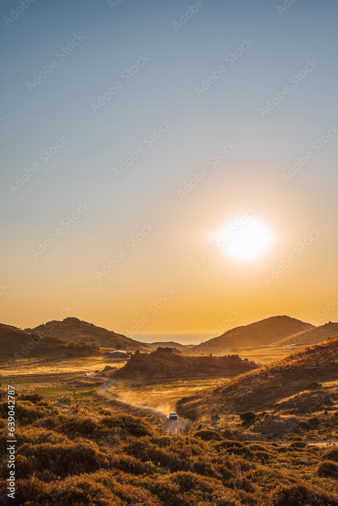 Romantic sunset view to Aegean Sea Lemnos or Limnos Island Greece, summer travel destination, bokeh light of car dust