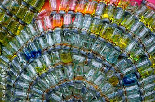 Close-Up View of Tiny Glass Bottles Wired Together
