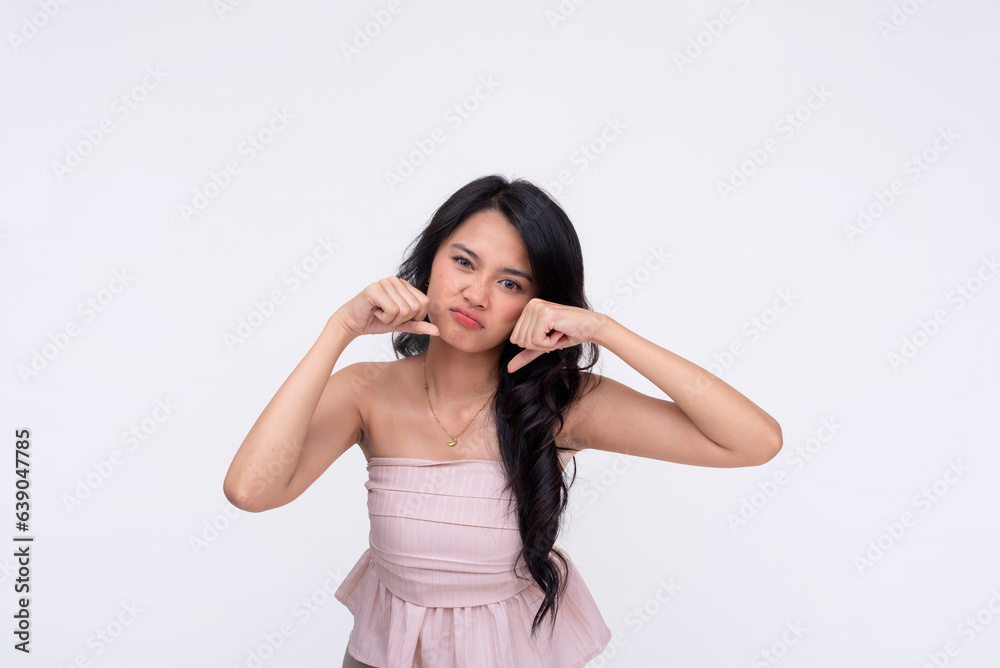 A young asian woman mocking someone making a sarcastic crying gesture. Isolated on a white background. A young asian woman mocking someone making a sarcastic crying gesture. Isolated on a white background.