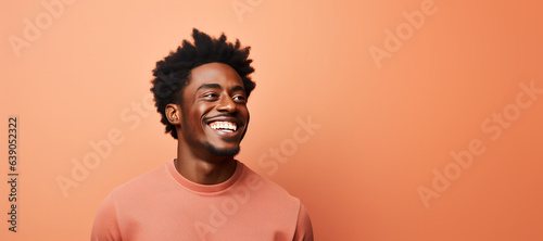 Portrait of a Black Male Looking Right on a Orange Background with Space for Copy
