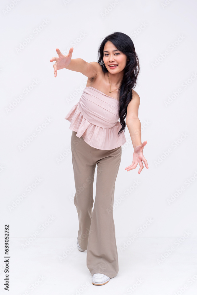 A extroverted and friendly young asian woman leans forward offering an embrace. A platonic wholesome hug. Whole body picture isolated on a white background. A extroverted and friendly young asian woman leans forward offering an embrace. A platonic wholesome hug. Whole body picture isolated on a white background.