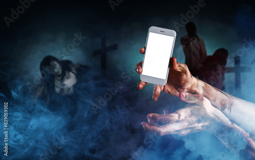 Hands of zombie with mobile...