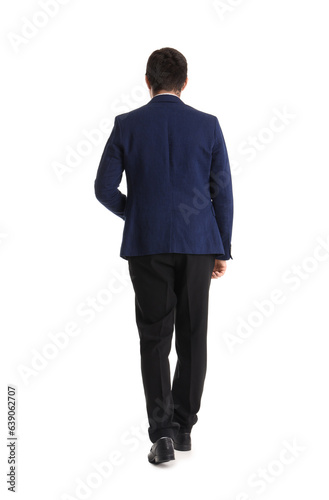 Young businessman walking away on white background, back view