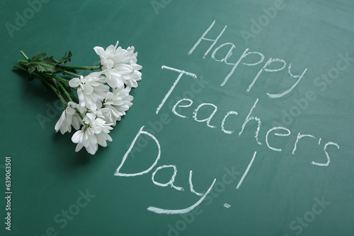 Bouquet of beautiful flowers with beret and text HAPPY TEACHER'S DAY on green chalkboard
