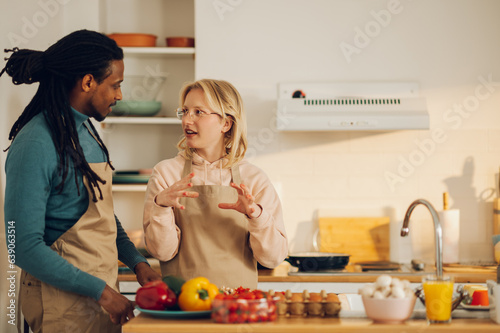 A blond wife is explaining the recipe while her Arabic husband is listening to her.