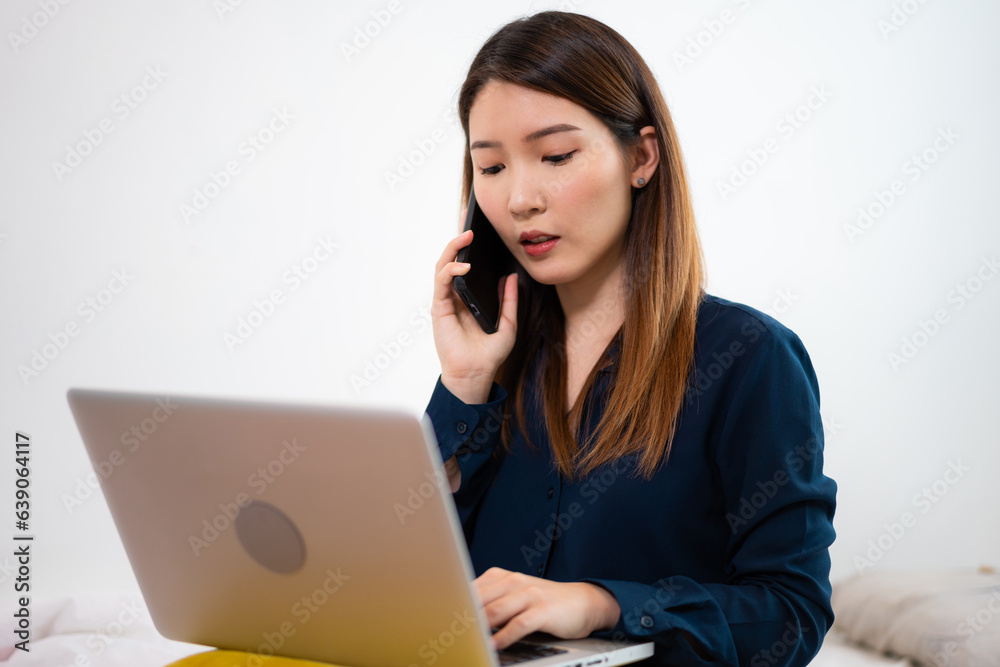 Asian woman using a laptop working long-distance at home Asian woman using a laptop working long-distance at home