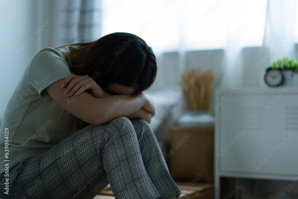 A depressed woman sitting in the bedroom A depressed woman sitting in the bedroom