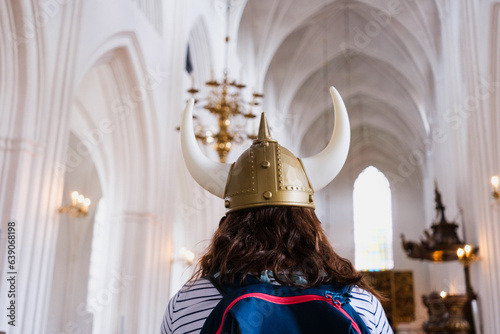 Tourist inside a church in a Viking costume, disrespectful of the space for religious gathering. photo
