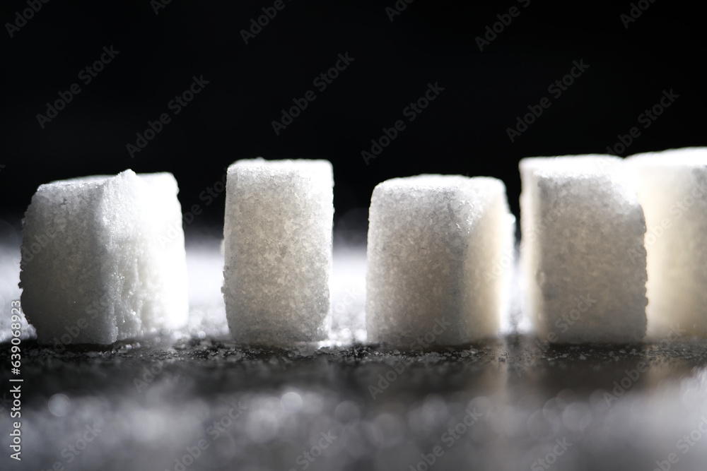 Close up of white cube sugar on black background
