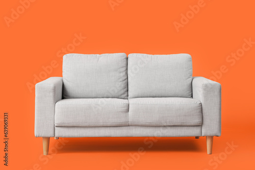 Cozy grey sofa on red background