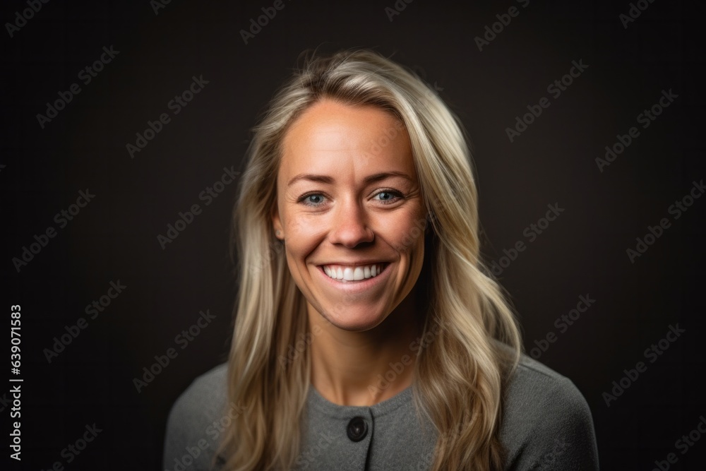 Portrait of a beautiful blond woman smiling at the camera on a black background Portrait of a beautiful blond woman smiling at the camera on a black background