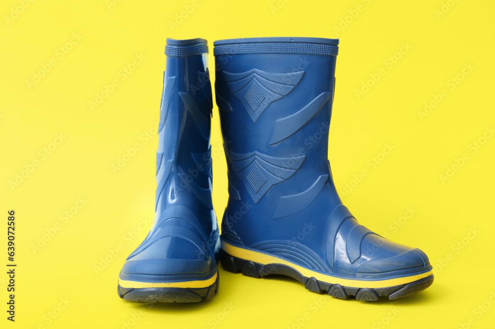 Blue gumboots on yellow background Blue gumboots on yellow background