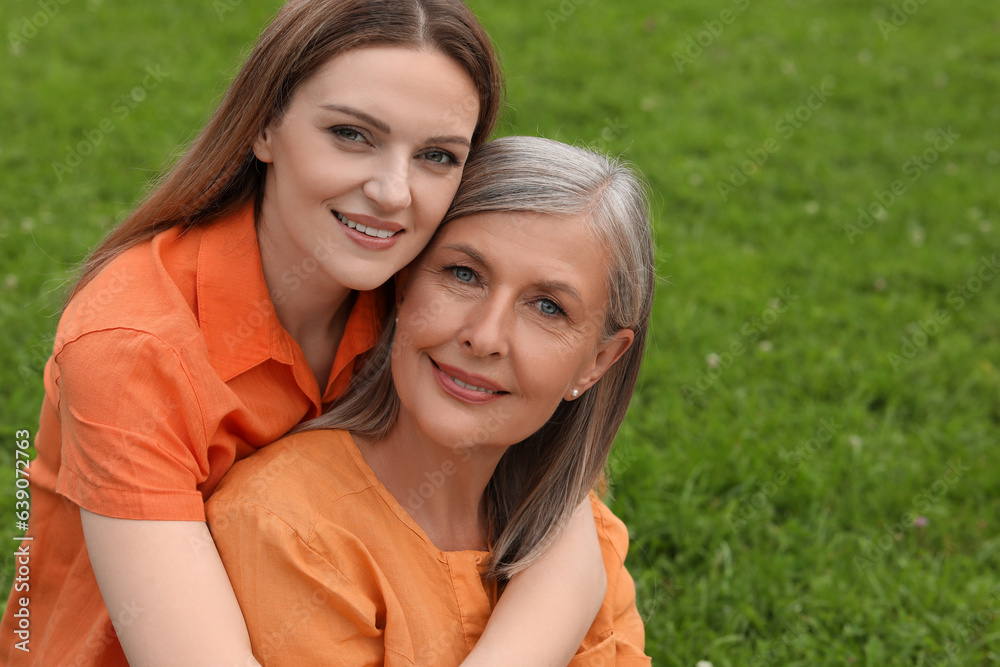 Happy mature mother and her daughter outdoors Happy mature mother and her daughter outdoors