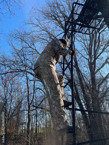 Hunting Hunter Woman Walking Away in Camouflage Climbing Tree Stand