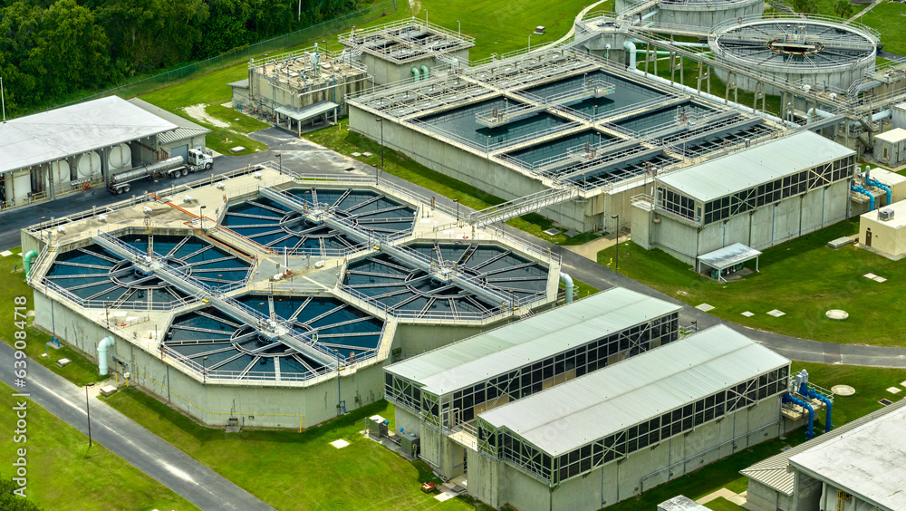 Aerial view of modern water cleaning facility at urban wastewater treatment plant. Purification process of removing undesirable chemicals, suspended solids and gases from contaminated liquid
