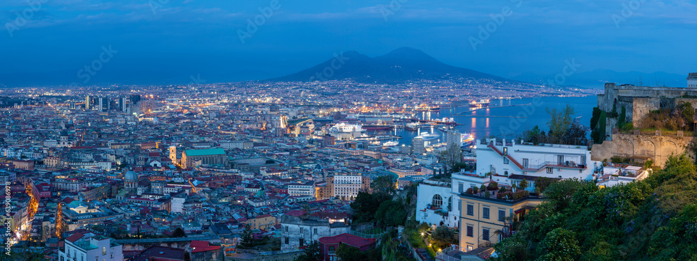 Naples - The cityscape with the Vesuvius vulcan at dusk.