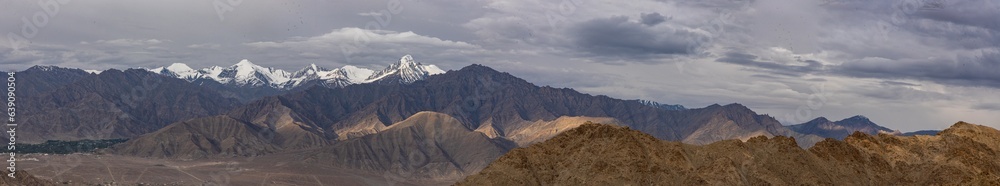 Panoramic view of high-altitude snowcapped mountain ranges of Ladakh, India 