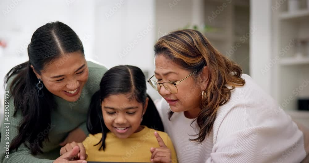 Grandmother, mother and girl on a tablet as a family playing a game in the living room of their home together. Love, education or internet with a senior woman and daughter teaching a kid online Grandmother, mother and girl on a tablet as a family playing a game in the living room of their home together. Love, education or internet with a senior woman and daughter teaching a kid online