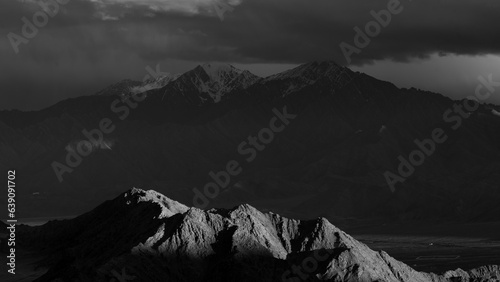 A landscape of light and shadows falling on mountains as fine art