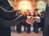 Close up shot of shaking hands of graduate. Graduation ceremony