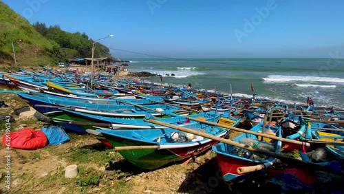 Iconic blue fishing boats of Indonesia moored on Menganti beach photo
