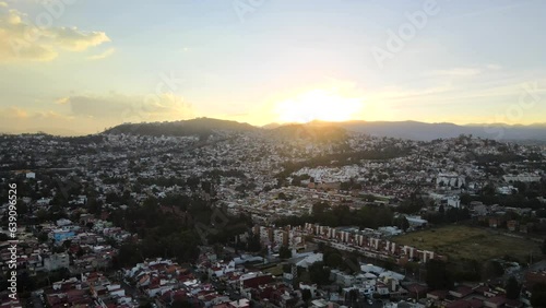 Captivating Aerial View of Naucalpan Cityscape from Drone during sunset.  The drone reveals the intricate tapestry of urban life and natural beauty. photo