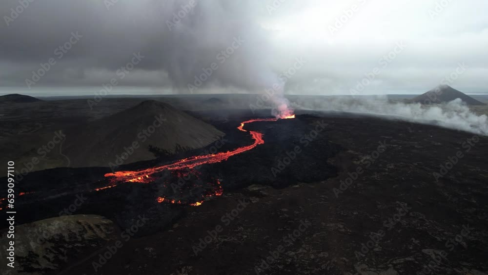 counter clockwise high angle drone shot of the litli hrutur volcano in iceland with fog and smoke